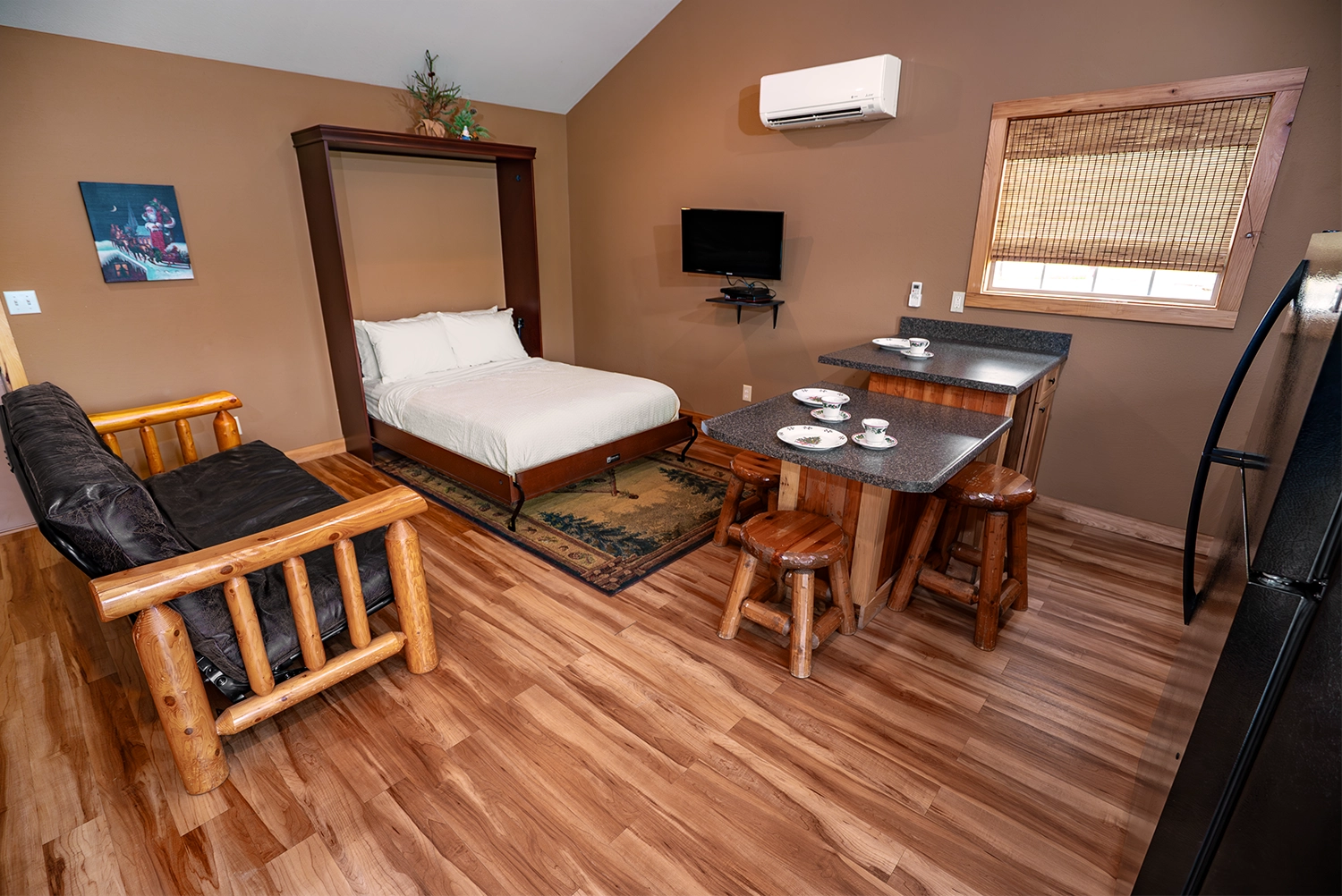 Living Room, Dining Area, and Kitchen of a One-Bedroom Cottage at Santa's Cottages.