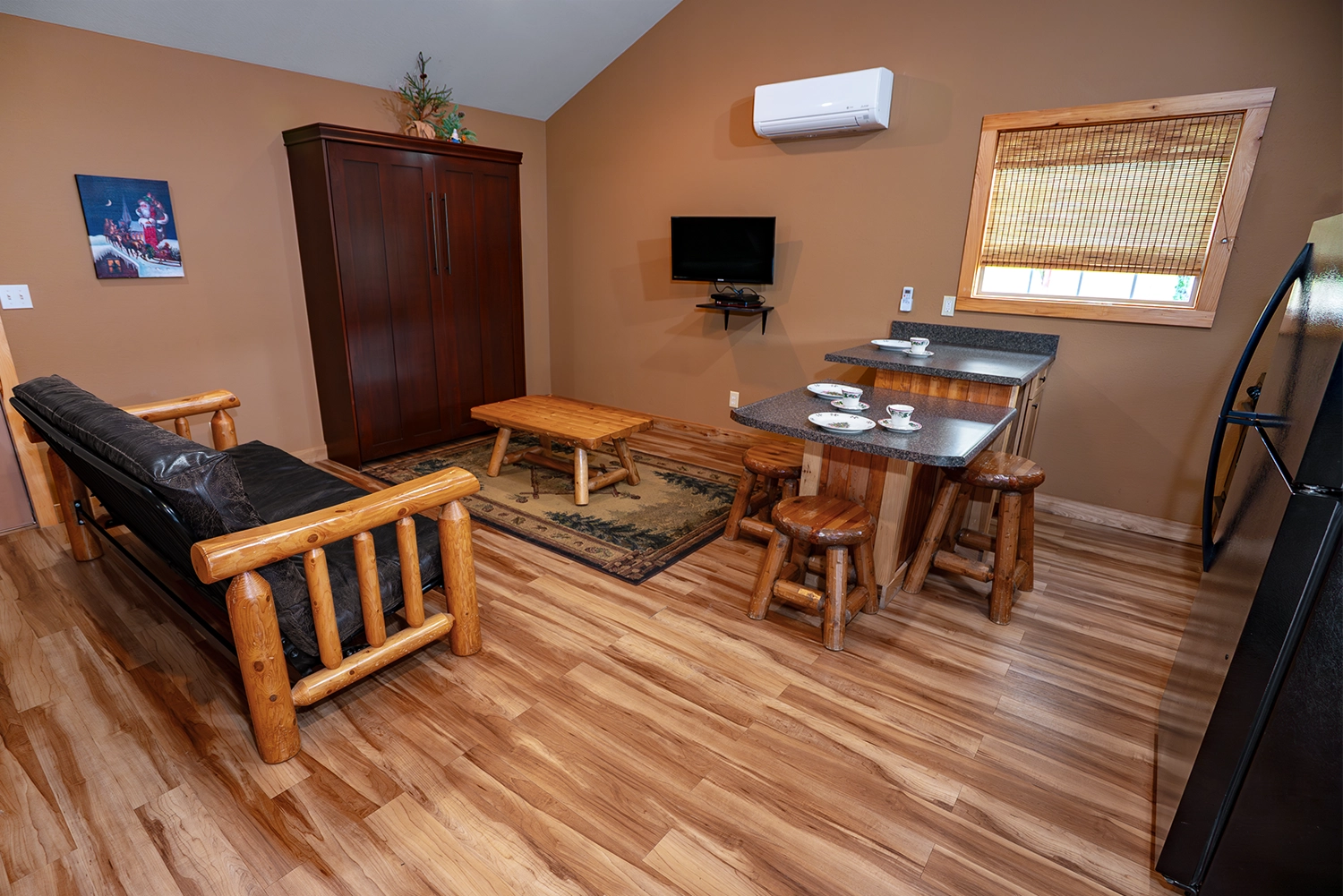 Living Room, Dining Area, and Kitchen of a One-Bedroom Cottage at Santa's Cottages.